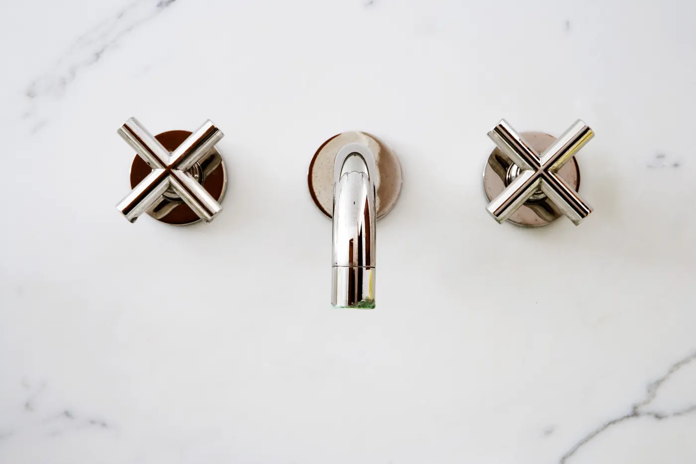Close detail of marble and brushed gold fixtures