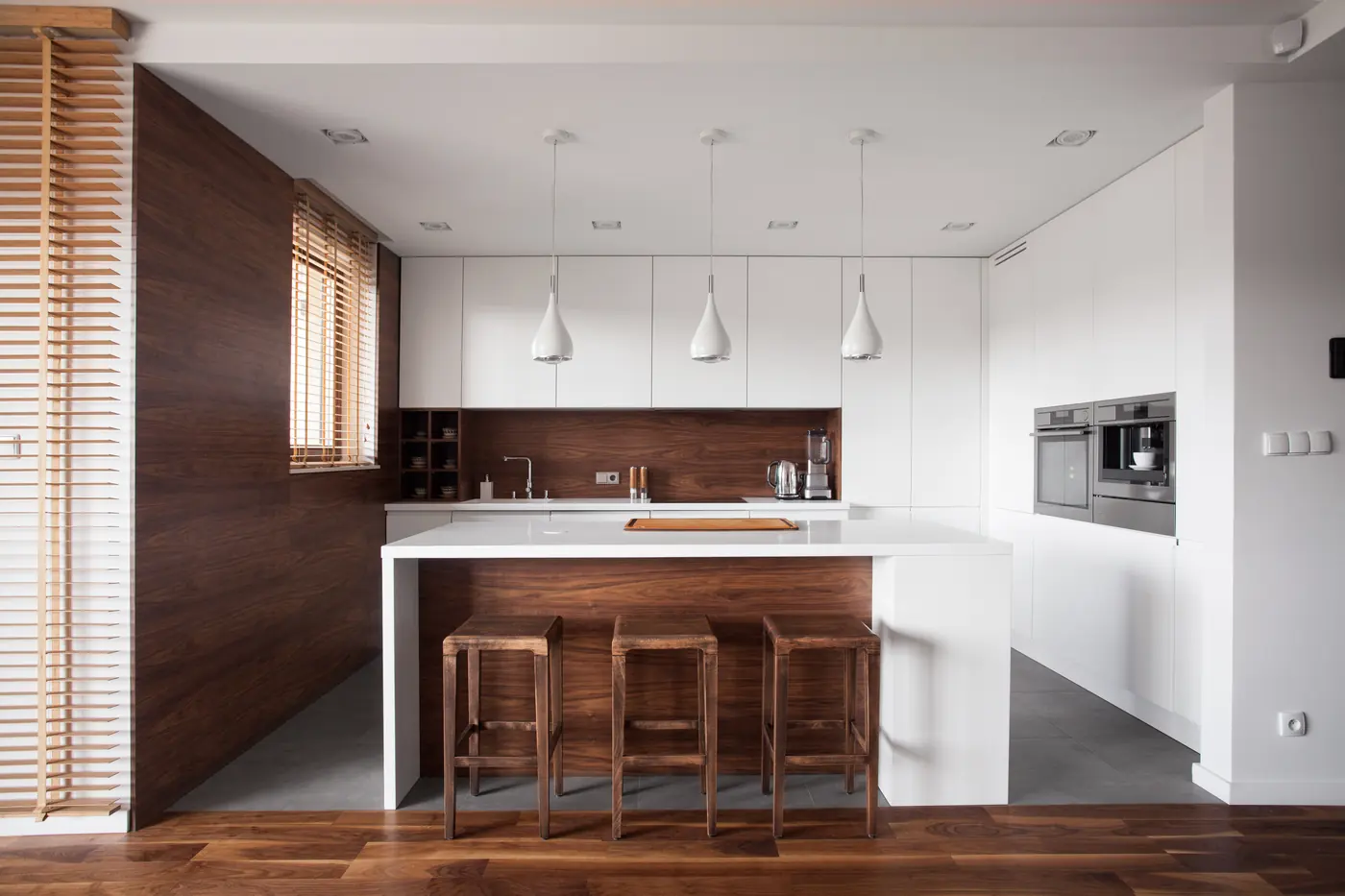Dark wood kitchen renovation with island seating and pendant lighting